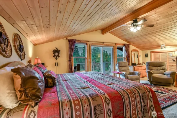 a bedroom with a large bed and a large window