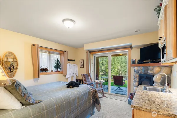 a bedroom with a bed and glass door