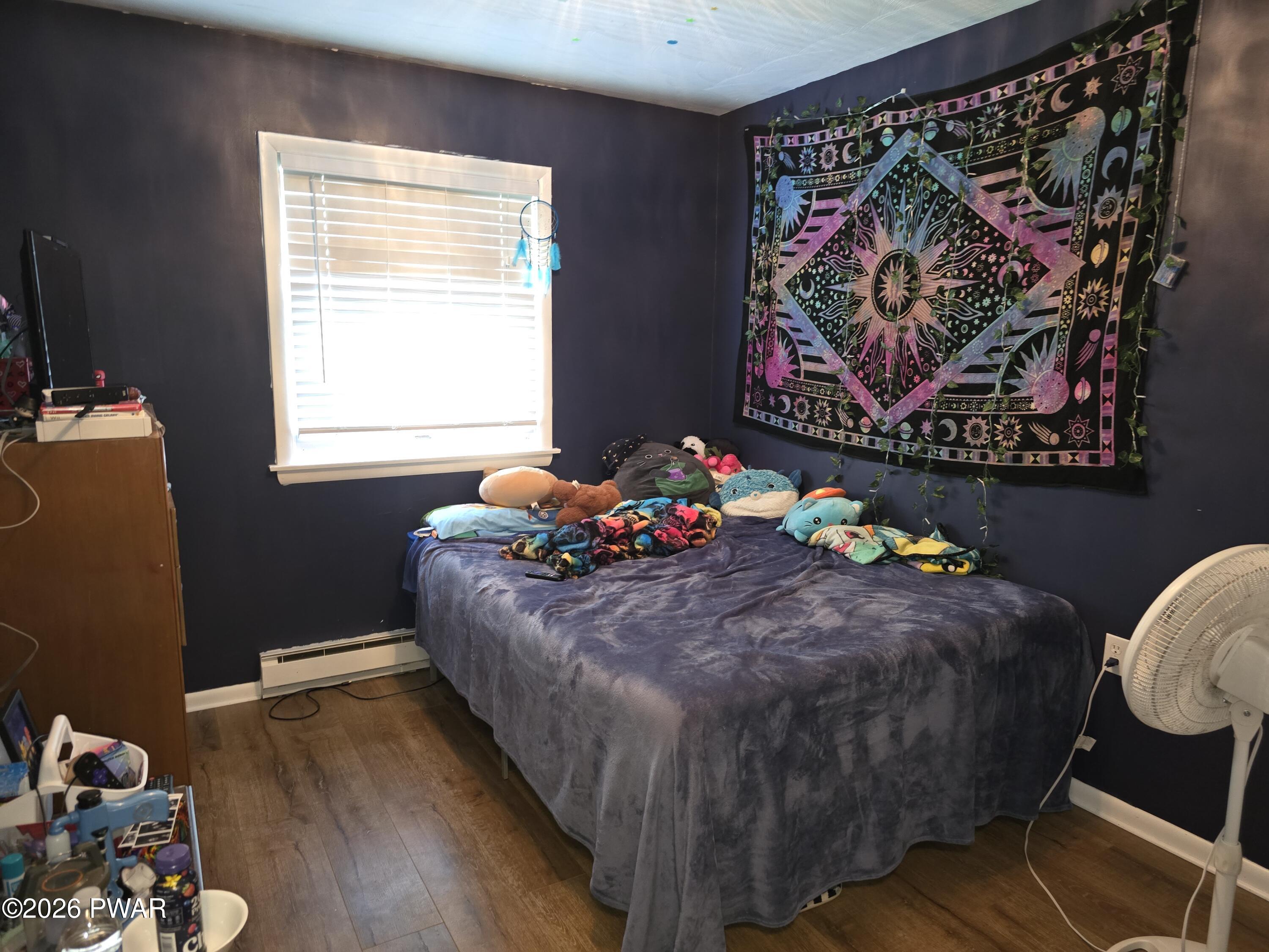 107 Keystone Hls Road, Unit 404 Factoryville, PA 18419 - Photo 6 of 23 a bed sitting in a bedroom next to a window