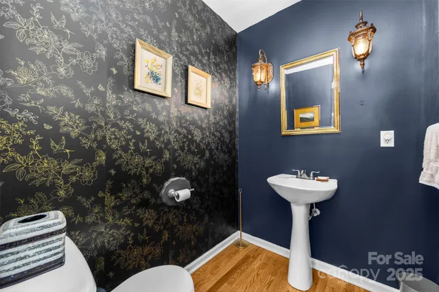 a bathroom with a sink mirror and toilet