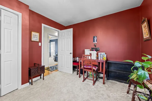 a dining room with furniture and a potted plant