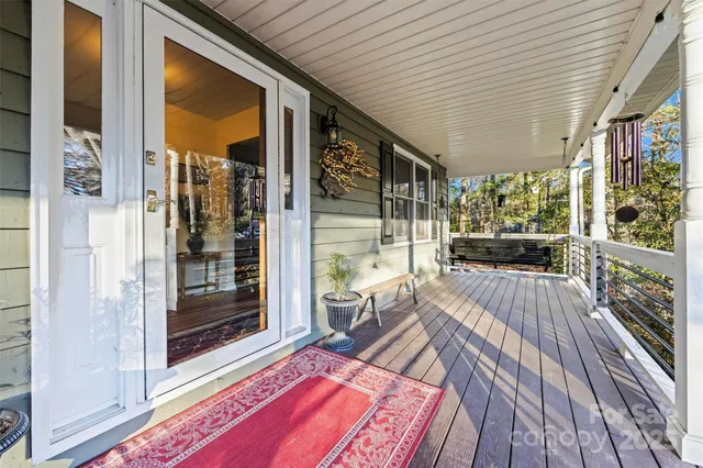 a balcony with furniture and a potted plant