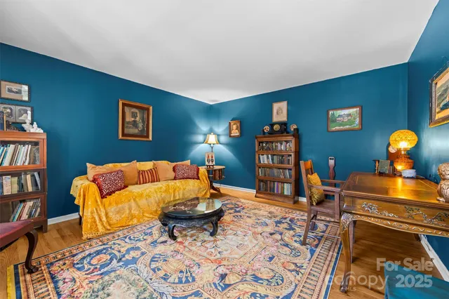 a living room with furniture and a bookshelf