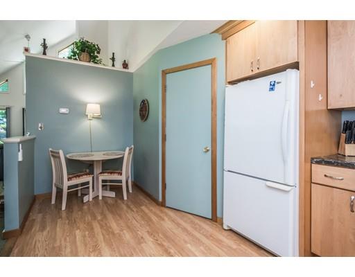 9 Sutcliffe Road Holland, MA 01521 - Photo 17 of 42 a kitchen with stainless steel appliances refrigerator dining table and chairs