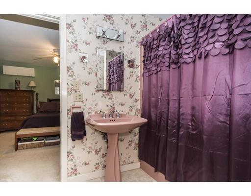 9 Sutcliffe Road Holland, MA 01521 - Photo 23 of 42 a bathroom with a sink and mirror with toilet
