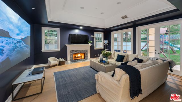 a living room with furniture a flat screen tv and a fireplace