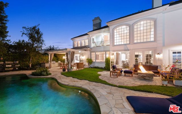 a view of a house with backyard porch and sitting area