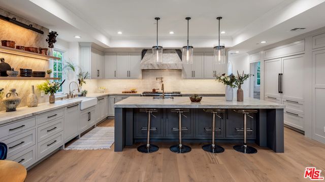 a kitchen with stainless steel appliances kitchen island granite countertop a sink and cabinets