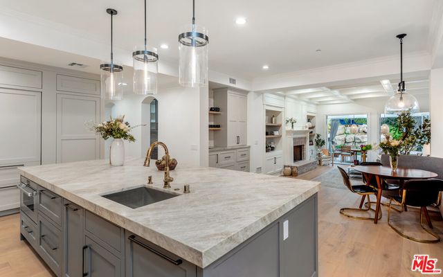 a kitchen with center island table and chairs in it