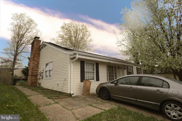 a view of a car parked in front of a house