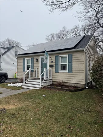 a view of a house with a yard and sitting area
