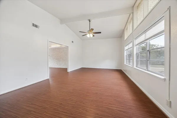 wooden floor in an empty room with a window