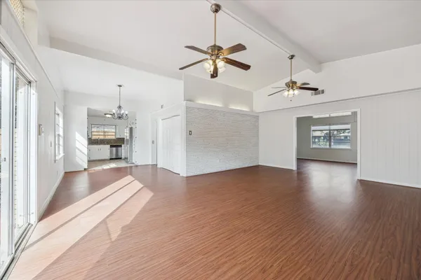a view of a kitchen with wooden floor and a kitchen