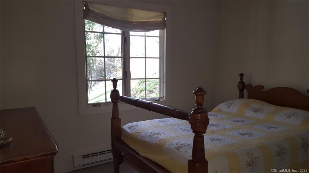261 Taconic Road Salisbury, CT 06068 - Photo 15 of 20 a bed sitting in a bedroom next to a window