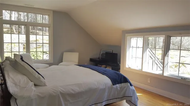 a bed sitting in a bedroom next to a window