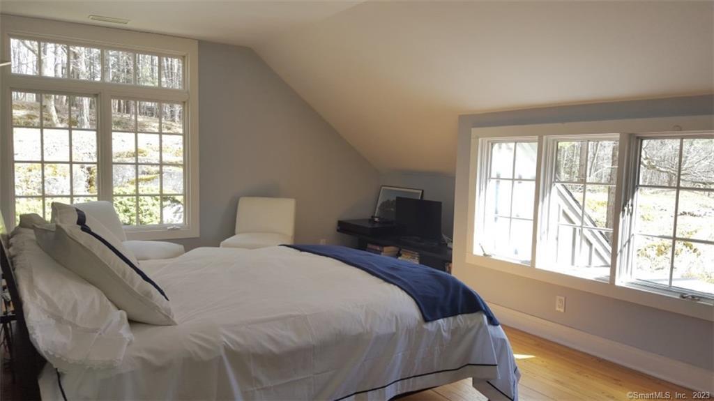 261 Taconic Road Salisbury, CT 06068 - Photo 17 of 20 a bed sitting in a bedroom next to a window
