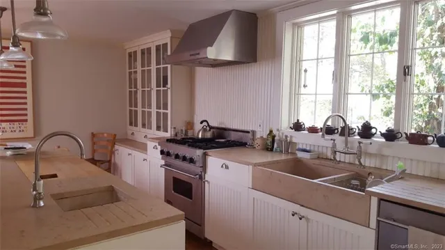 a kitchen with a sink cabinets and a stove