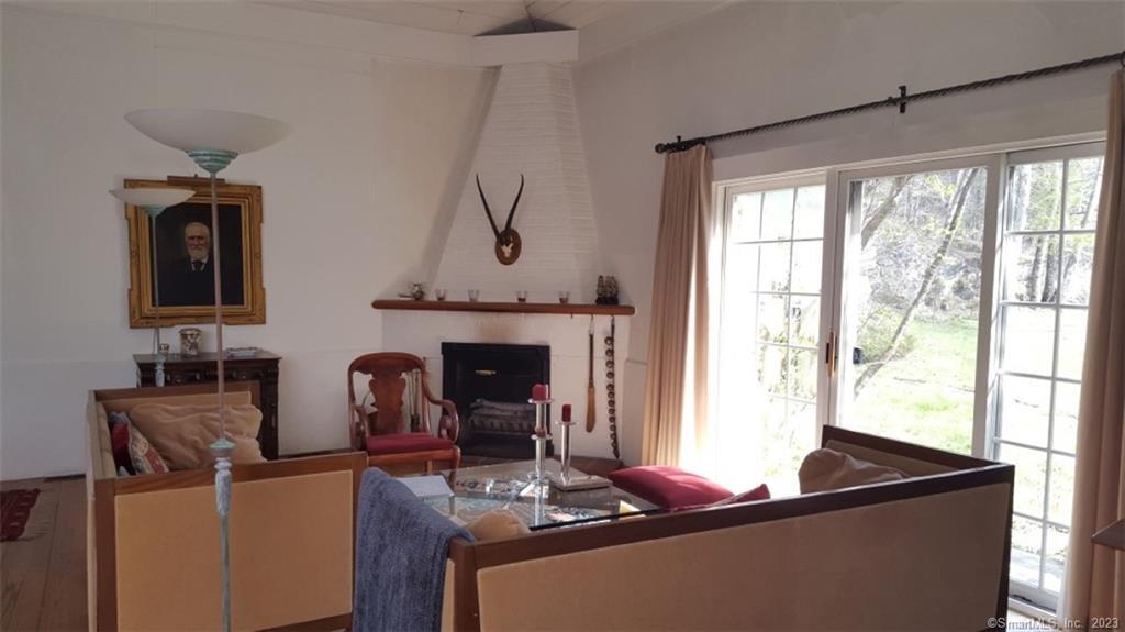261 Taconic Road Salisbury, CT 06068 - Photo 5 of 20 a living room with furniture and a fireplace