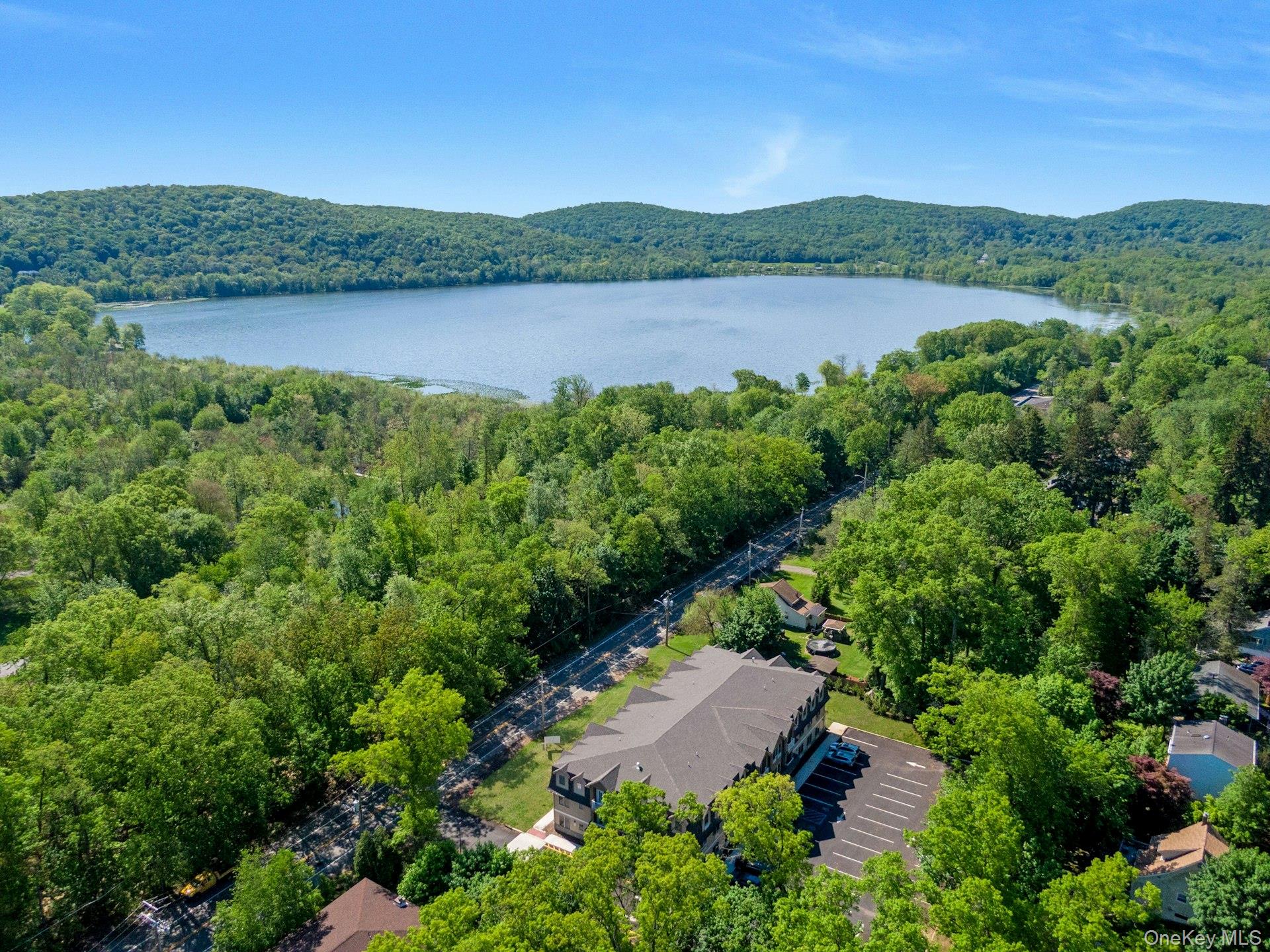 a view of a lake and green valley