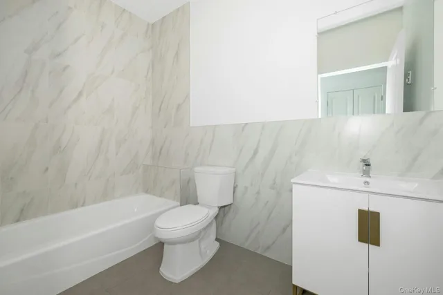 a bathroom with a sink a toilet and bathtub