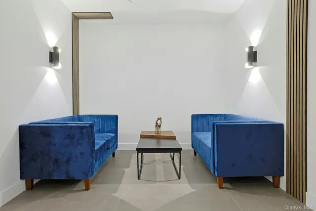 a living room with furniture and a lamp