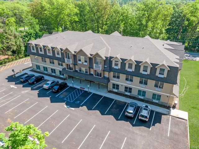 a view of a large building with a yard