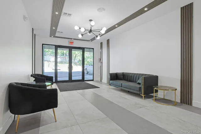 a spacious bedroom with a bed and a chandelier