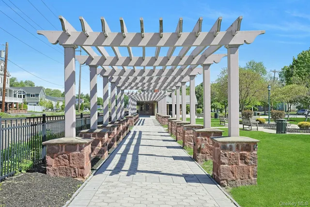 a view of a patio with table and chairs potted plants and floor to ceiling window