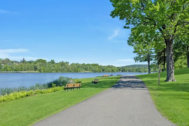 an aerial view of a house with green yard and lake view