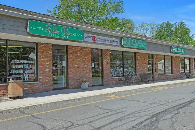 a front view of a building with parking