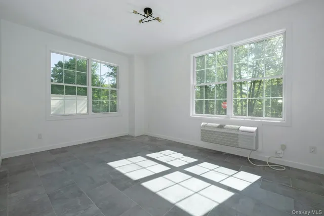 a room with a window and a fan