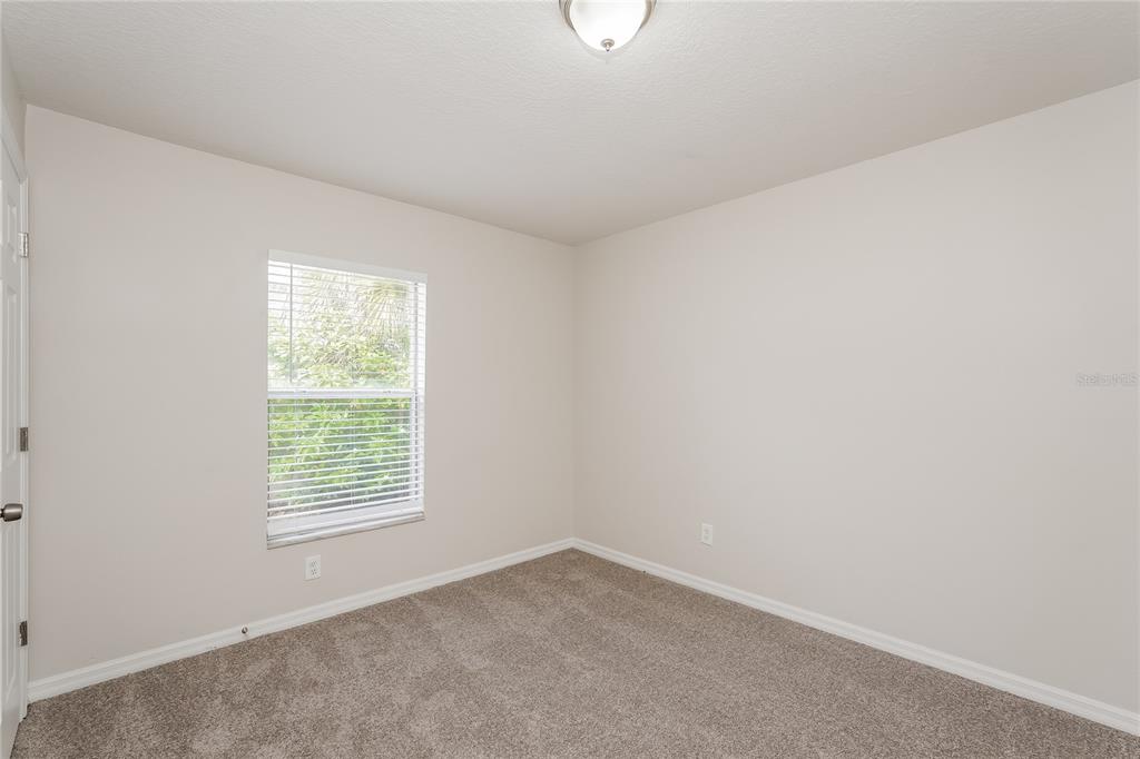 146 Hidden Lk Loop Haines City, FL 33844 - Photo 11 of 16 an empty room with windows