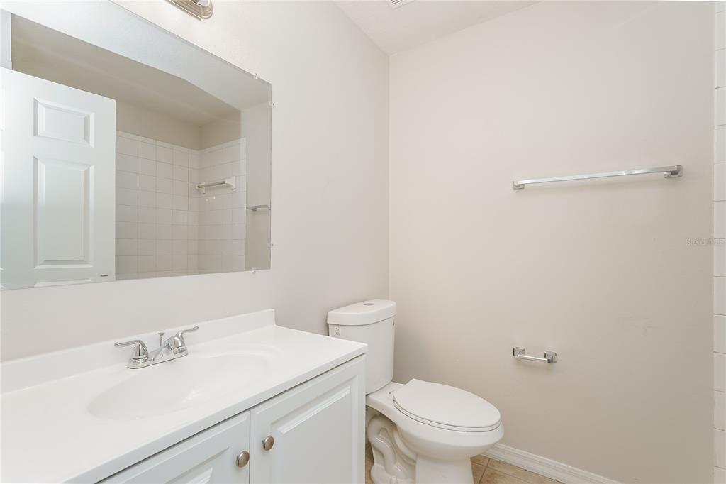 146 Hidden Lk Loop Haines City, FL 33844 - Photo 13 of 16 a bathroom with a sink a toilet and a mirror