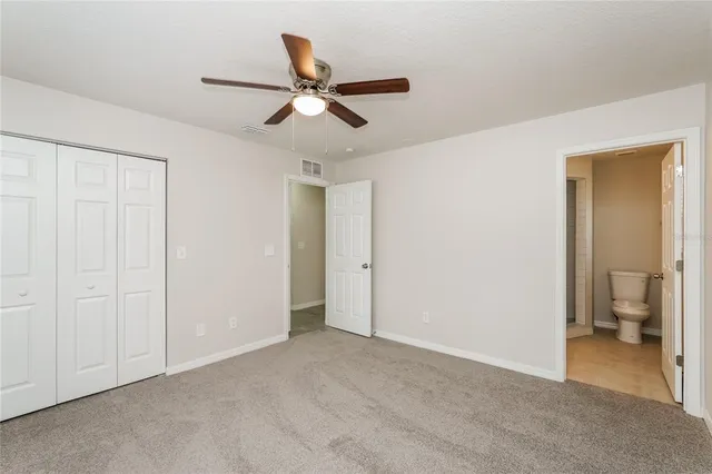 a view of an empty room and a bathroom