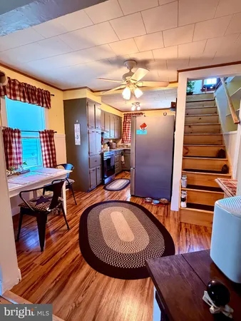 a view of a room with furniture and wooden floor