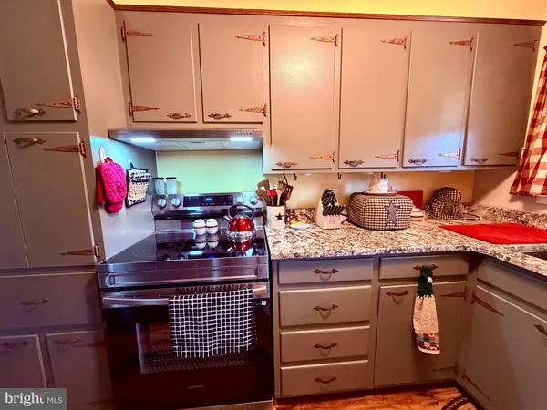 a kitchen with a stove and a refrigerator
