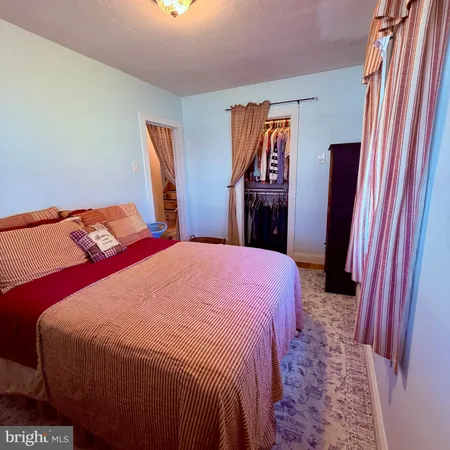 a bedroom with a bed and a mirror