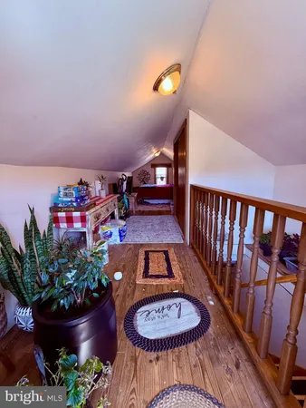 a view of a room with furniture and wooden floor
