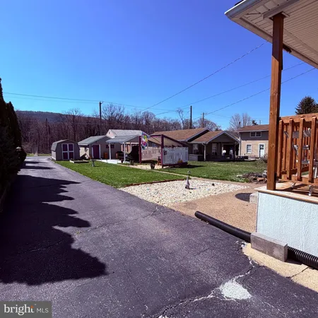 a view of a house with a yard porch and sitting area