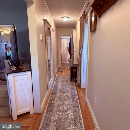 a view of hallway with wooden floor