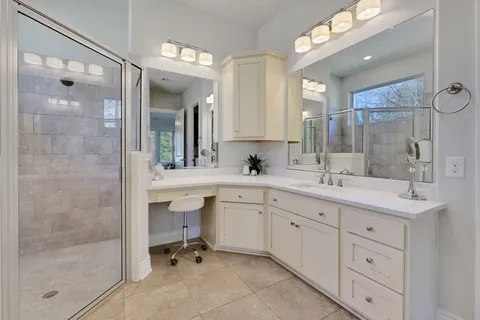 a bathroom with a sink vanity and a mirror