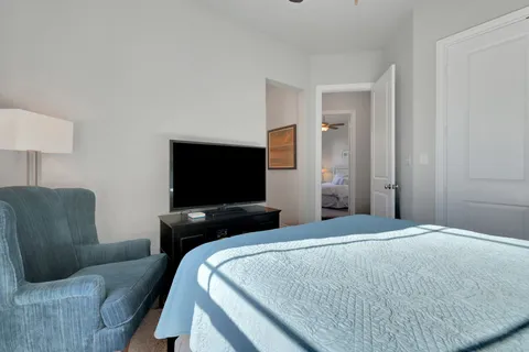 a bedroom with a bed couch and window