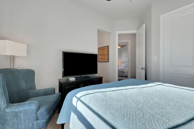 a bedroom with a bed couch and window