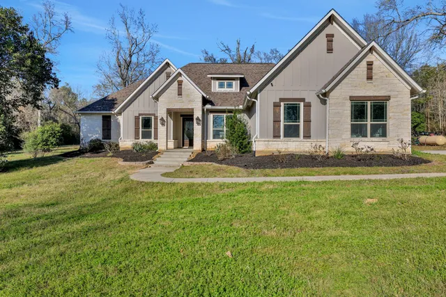 a aerial view of a house with a yard