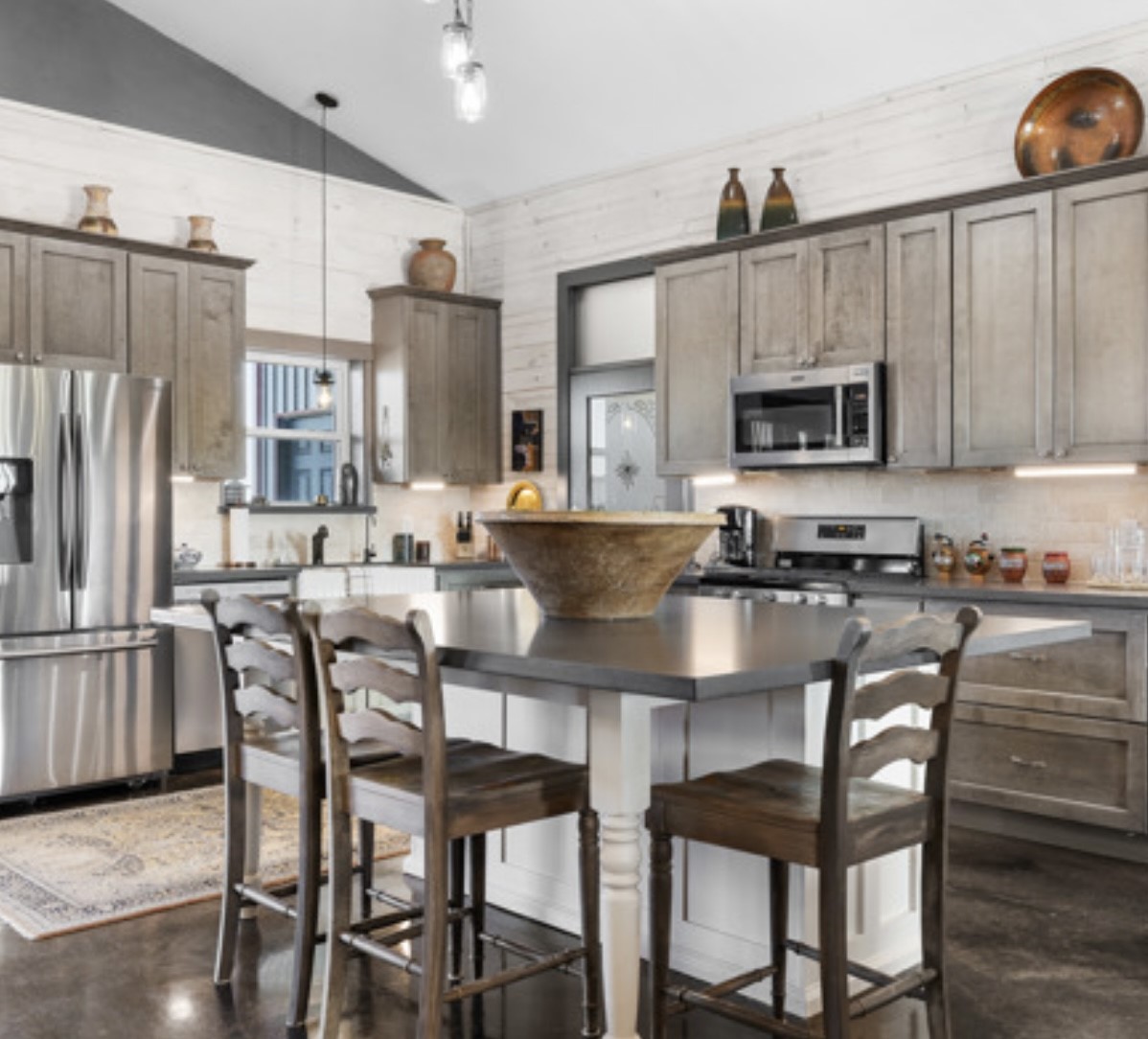 7210 Goehring Road Ledbetter, TX 78946 - Photo 11 of 47 a kitchen with a table chairs refrigerator and microwave