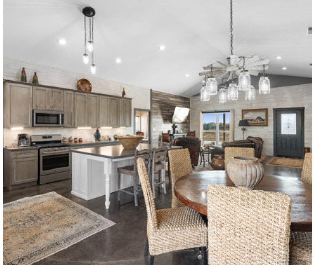 7210 Goehring Road Ledbetter, TX 78946 - Photo 13 of 47 a kitchen with kitchen island granite countertop a sink counter top space appliances and cabinets