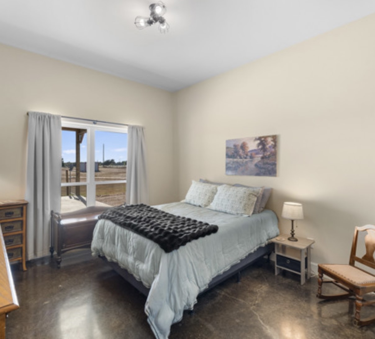 7210 Goehring Road Ledbetter, TX 78946 - Photo 18 of 47 a bedroom with a bed and wooden floor