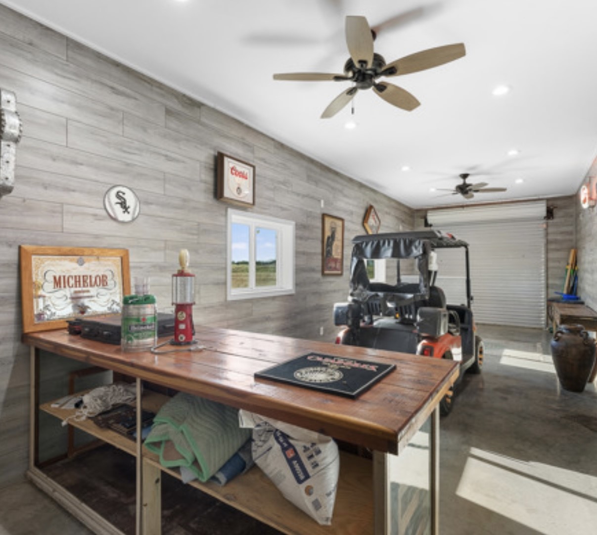 7210 Goehring Road Ledbetter, TX 78946 - Photo 23 of 47 a room with furniture a chandelier and a flat screen tv