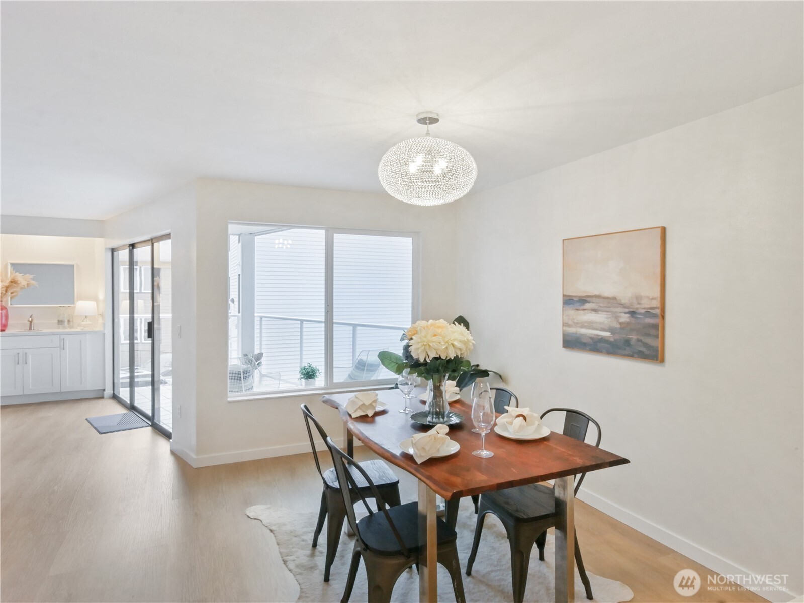 2104 Alki Avenue Southwest, Unit 306 Seattle, WA 98116 - Photo 15 of 40 a view of a dining room with furniture and wooden floor