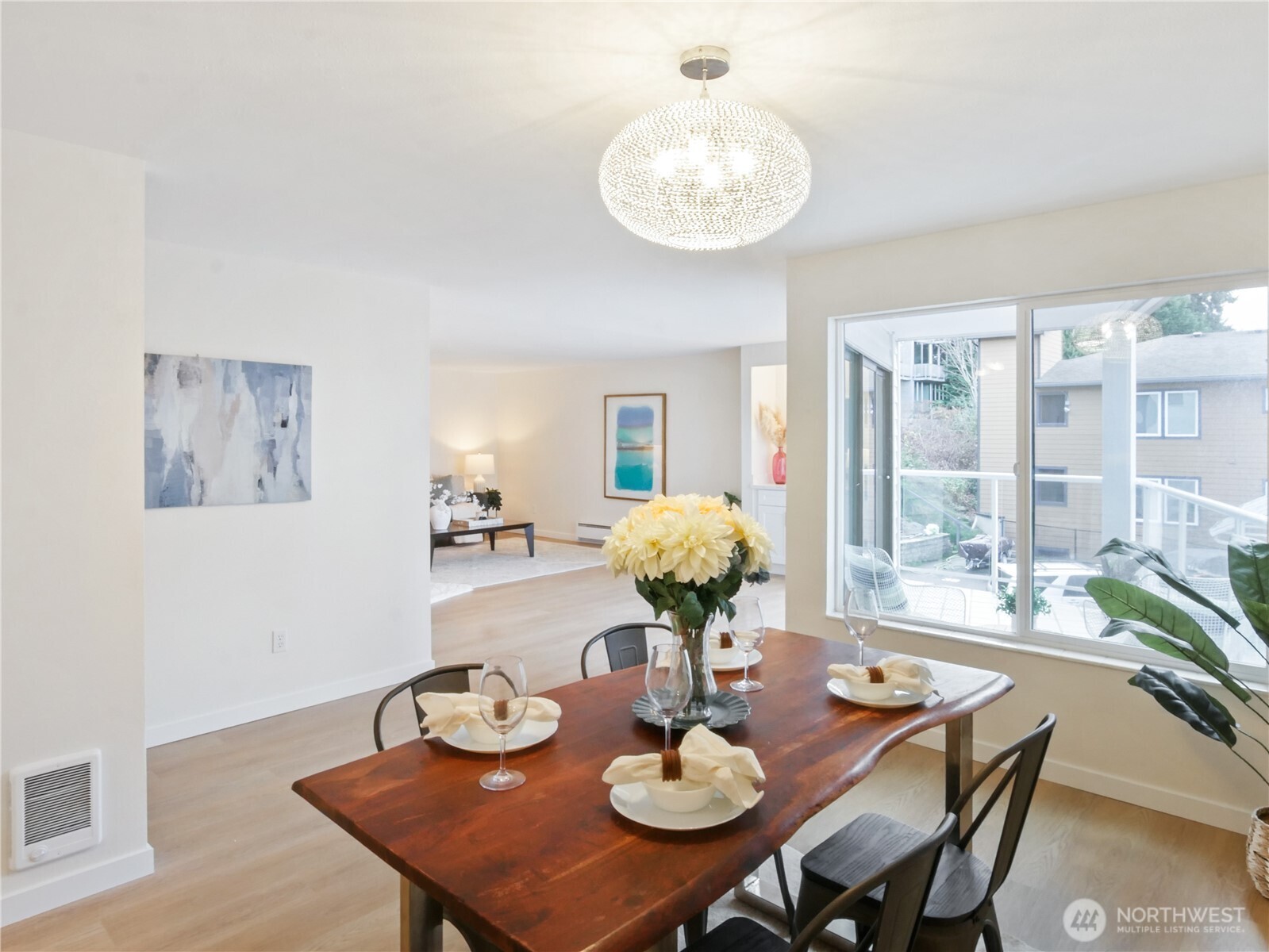 2104 Alki Avenue Southwest, Unit 306 Seattle, WA 98116 - Photo 17 of 40 a view of a dining room with furniture and chandelier